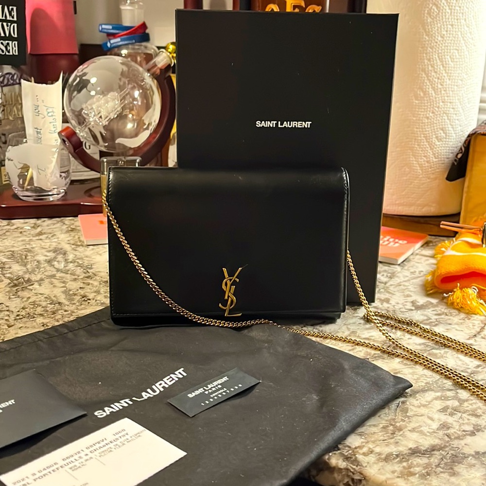YSL black leather clutch/cross body with gold chain.